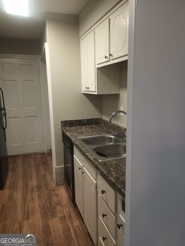 kitchen featuring dark hardwood / wood-style floors, fridge, sink, white cabinets, and dishwasher