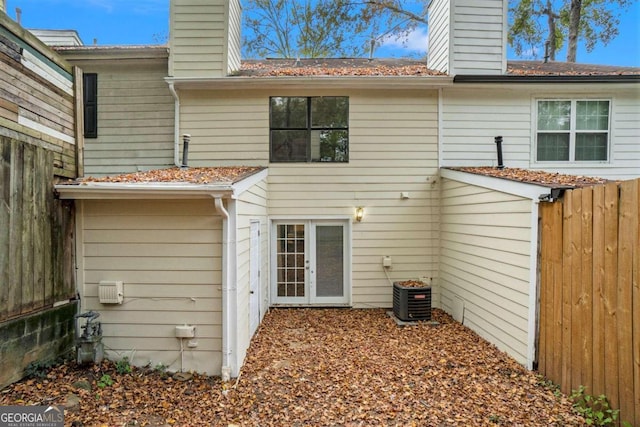 rear view of property featuring central AC unit