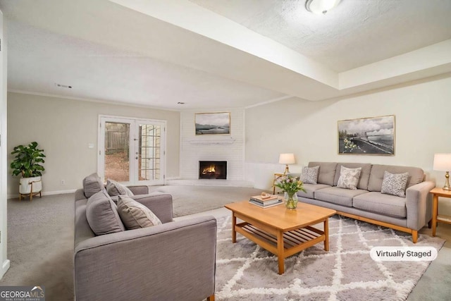 carpeted living room with a fireplace and a textured ceiling