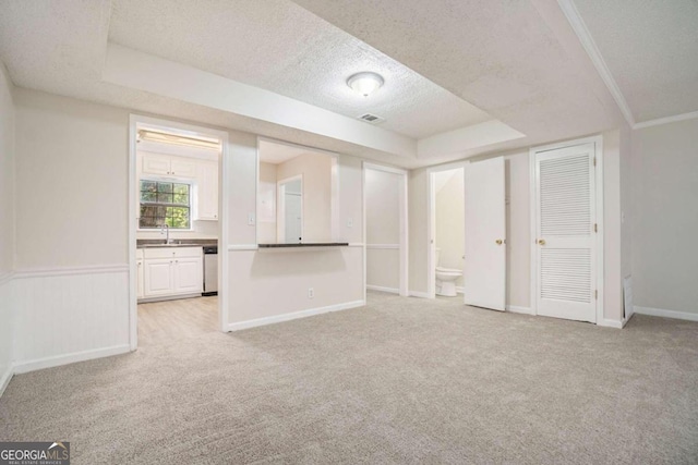 interior space featuring a textured ceiling and a raised ceiling