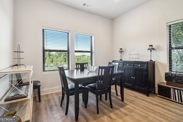 dining space with wood-type flooring