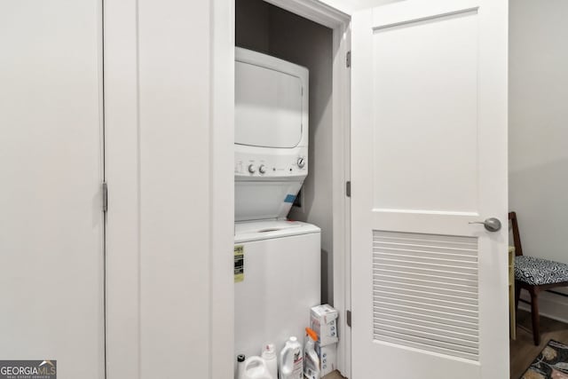 clothes washing area featuring stacked washer / drying machine