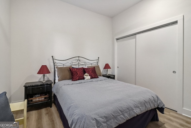 bedroom with a closet and hardwood / wood-style floors