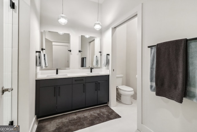 bathroom with vanity, tile patterned floors, and toilet