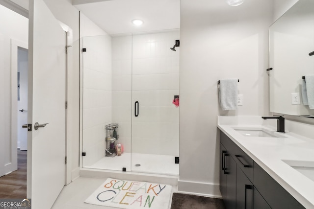 bathroom featuring vanity, hardwood / wood-style flooring, and a shower with shower door