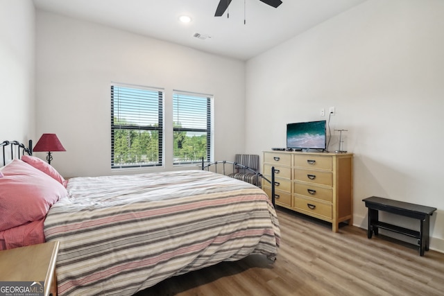 bedroom with light hardwood / wood-style floors and ceiling fan