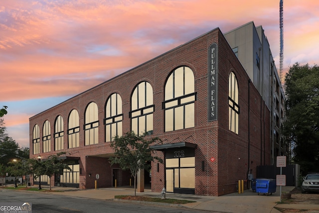 view of outdoor building at dusk