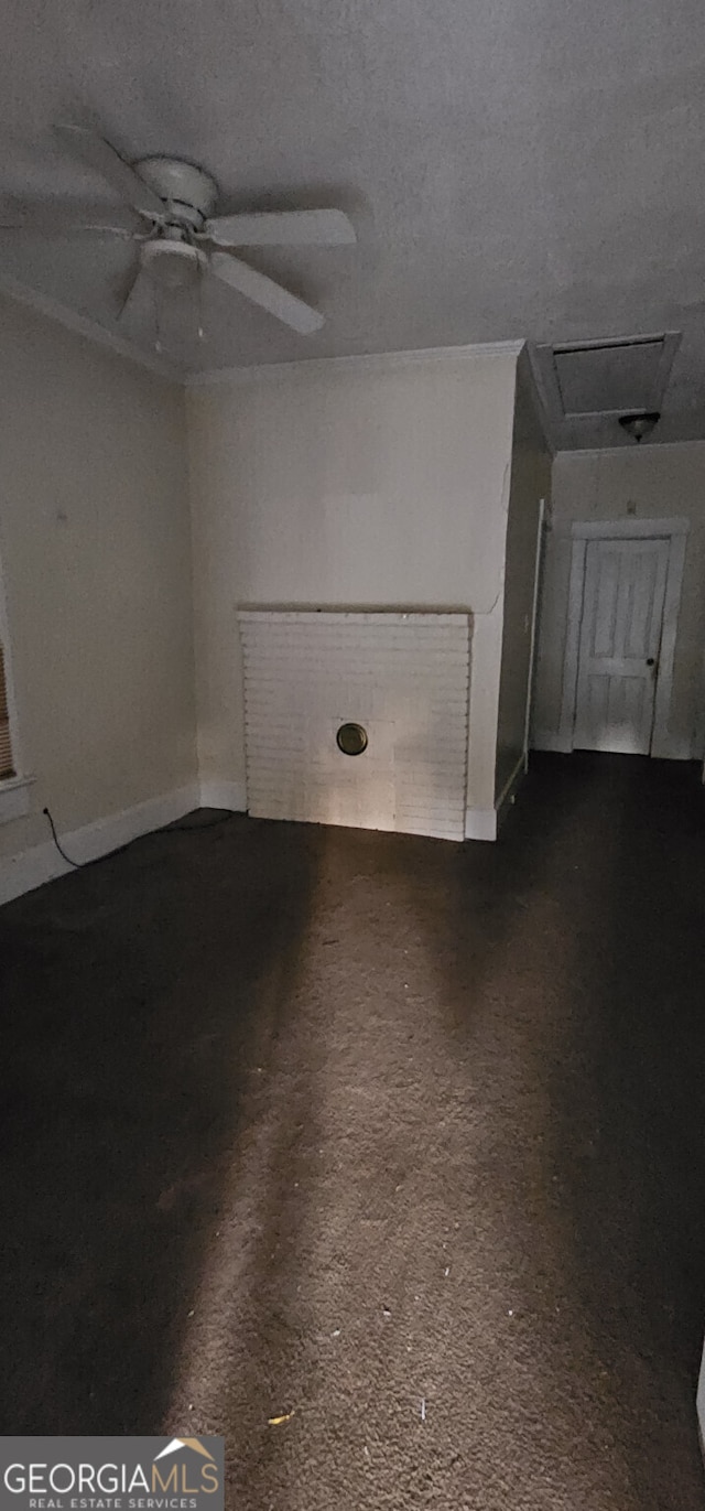 empty room featuring a textured ceiling, carpet floors, and ceiling fan