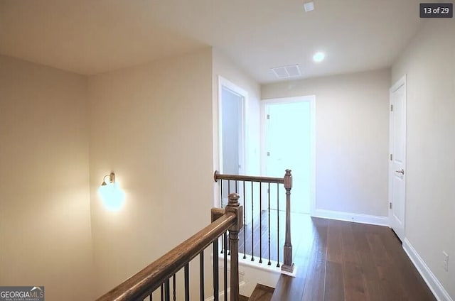 hall with dark wood-type flooring