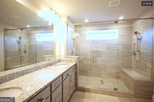 bathroom featuring vanity and a shower with shower door