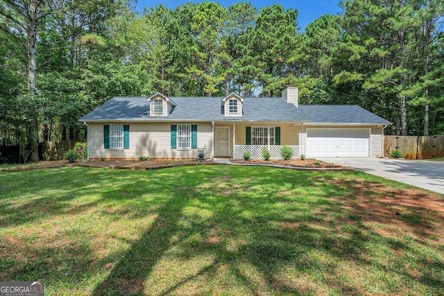 view of front of home featuring a garage and a front yard