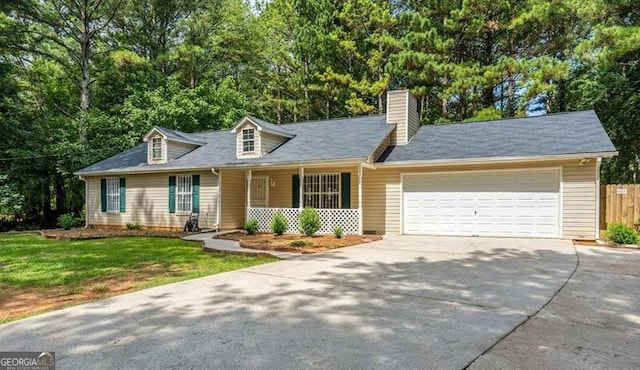 cape cod home with a garage and a front lawn