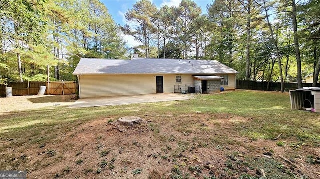 back of property with a patio and a yard