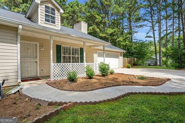 exterior space featuring a garage and covered porch