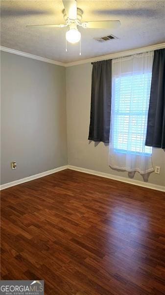 spare room featuring crown molding, dark wood-type flooring, and ceiling fan