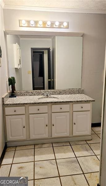 bathroom featuring vanity, tile patterned flooring, crown molding, and a textured ceiling