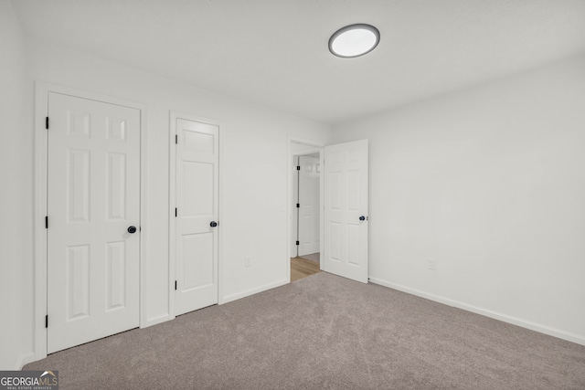 unfurnished bedroom featuring light colored carpet