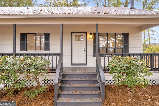 view of exterior entry featuring a porch