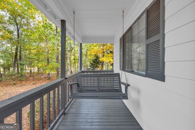 wooden terrace featuring covered porch