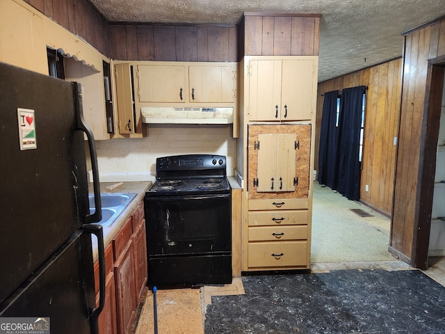 kitchen with black appliances, wood walls, sink, and a textured ceiling