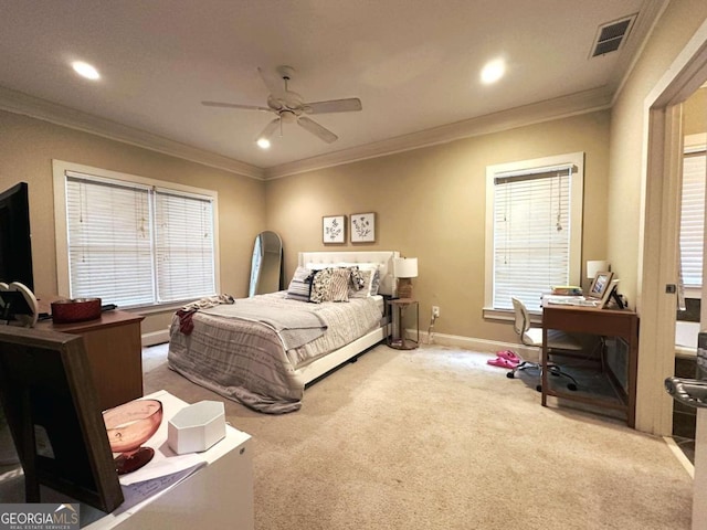 carpeted bedroom with multiple windows, ceiling fan, and crown molding