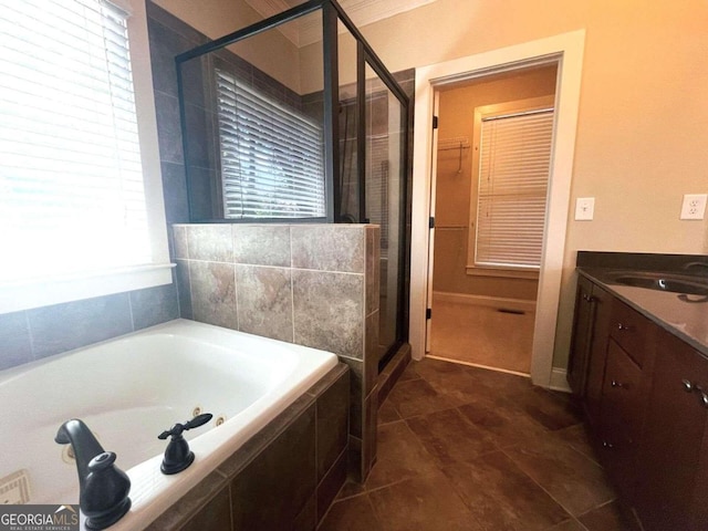 bathroom featuring plenty of natural light, vanity, and plus walk in shower