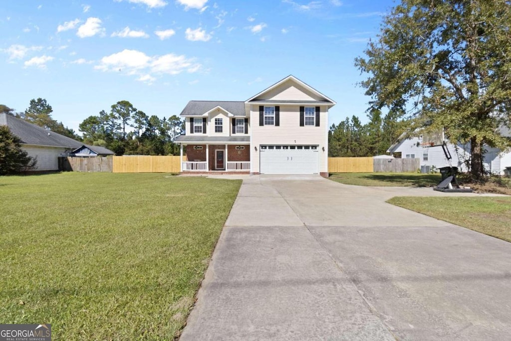 view of front of home with a garage, a front yard, and covered porch