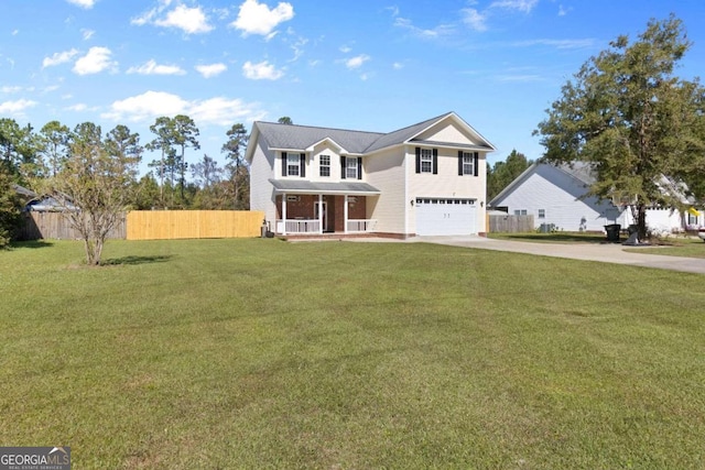 view of front of house featuring a garage, a front yard, and covered porch