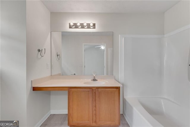 bathroom with shower / washtub combination, vanity, and baseboards