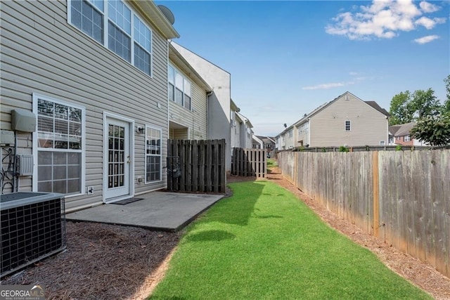 view of yard featuring cooling unit, a residential view, a fenced backyard, and a patio area