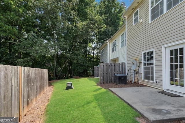 view of yard with a patio area, central air condition unit, and fence