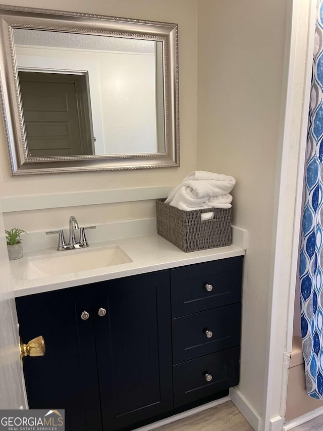 bathroom featuring wood-type flooring and vanity