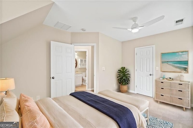 bedroom featuring ensuite bath, ceiling fan, light colored carpet, and vaulted ceiling