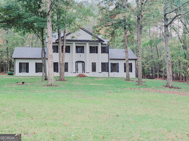 neoclassical / greek revival house with a front lawn