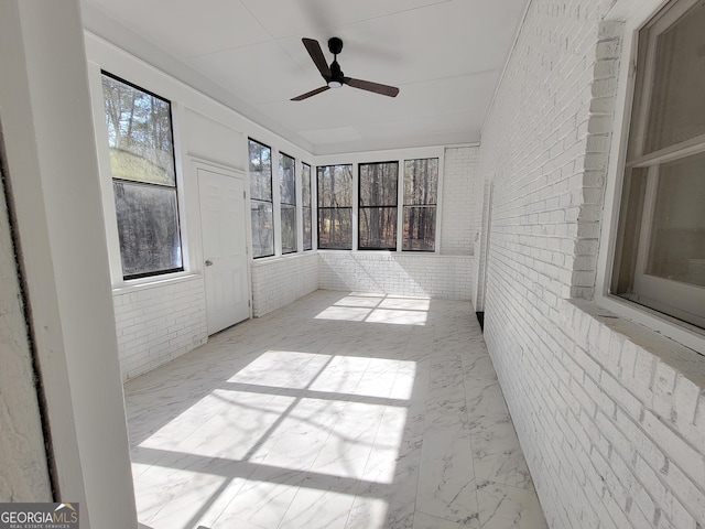 275 Allie Dr, Mcdonough, GA 30252 - unfurnished sunroom with a ceiling fan, brick wall, and marble finish flooring