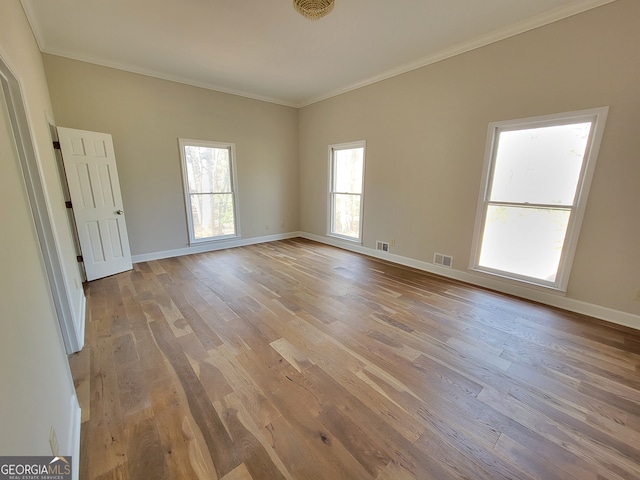 unfurnished room with light hardwood / wood-style flooring and crown molding