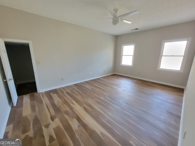 unfurnished room with hardwood / wood-style floors and ceiling fan