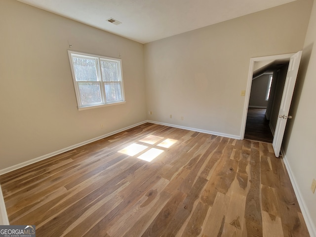 spare room with hardwood / wood-style flooring