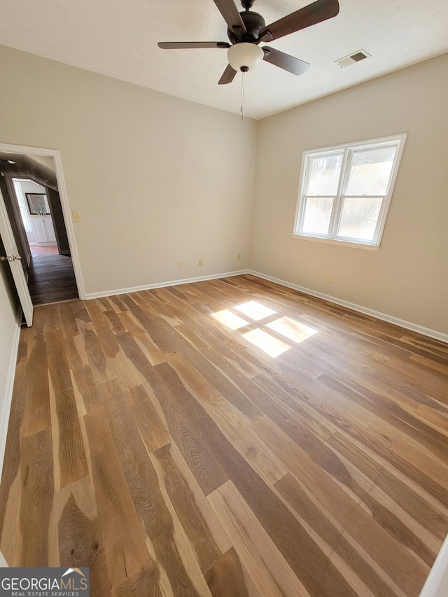 unfurnished room with hardwood / wood-style floors and ceiling fan