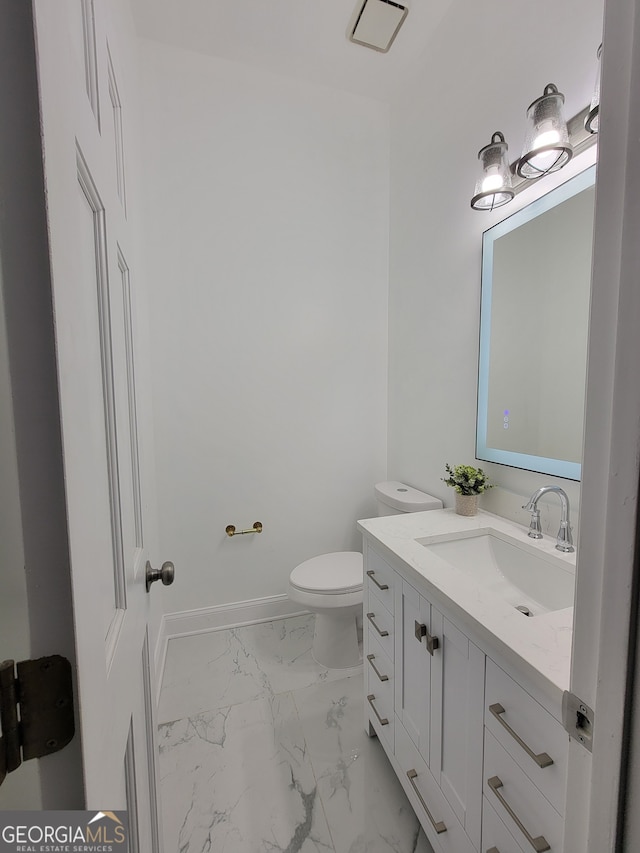 bathroom with vanity and toilet