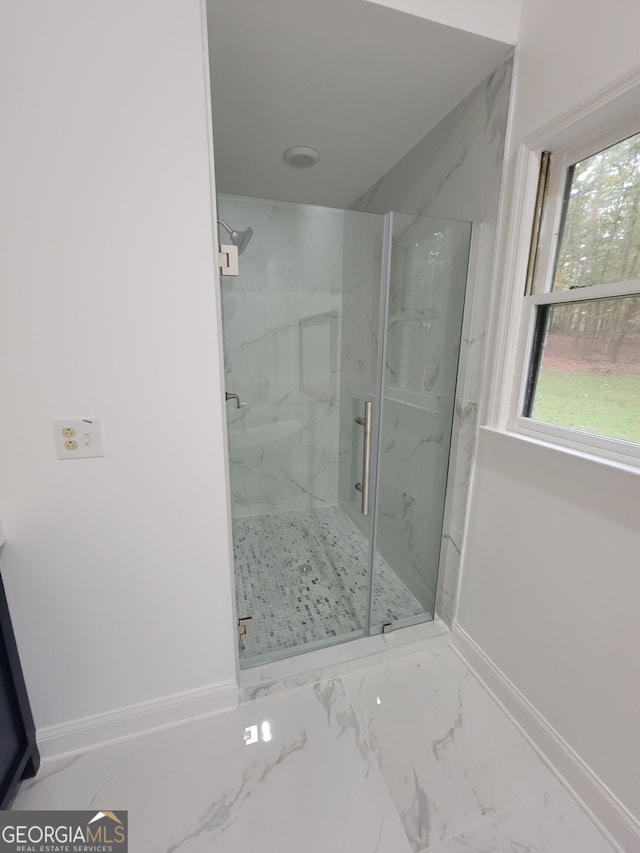 bathroom with a shower with shower door