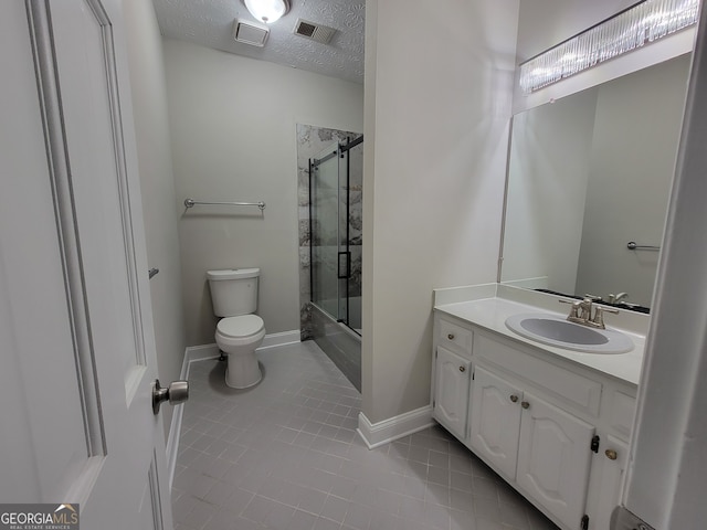 bathroom with vanity, tile patterned flooring, toilet, and a textured ceiling