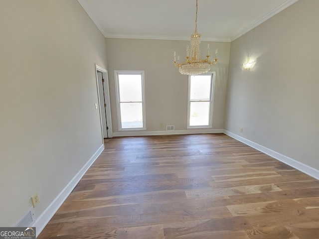 275 Allie Dr, Mcdonough, GA 30252 - spare room featuring a chandelier, crown molding, wood finished floors, and baseboards