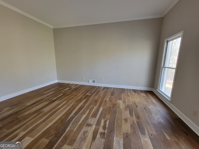 unfurnished room with dark wood-type flooring, a wealth of natural light, and crown molding