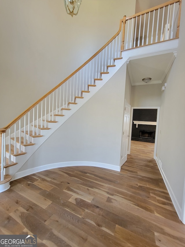 stairway featuring hardwood / wood-style flooring and a high ceiling