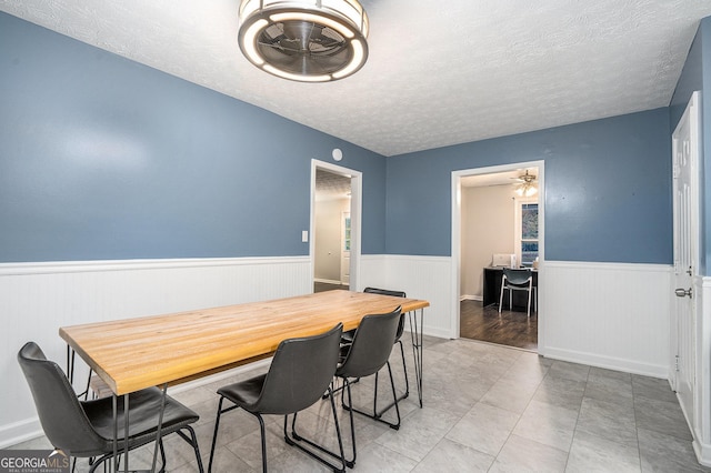 dining room featuring a textured ceiling and ceiling fan