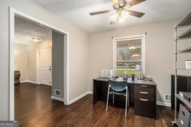 office area with ceiling fan, dark hardwood / wood-style flooring, and a textured ceiling