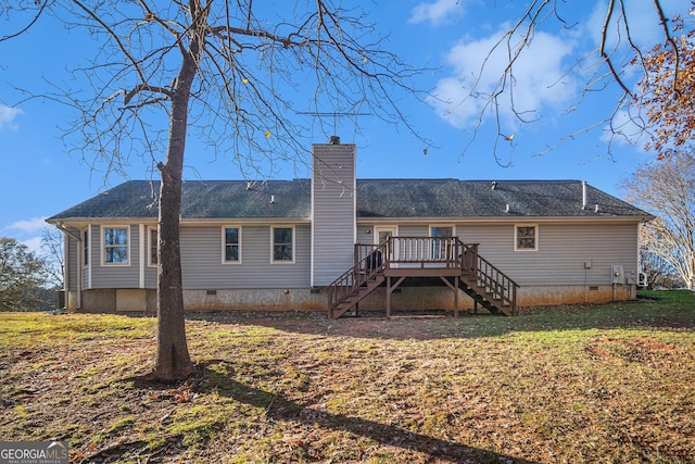 rear view of property with a yard and a wooden deck