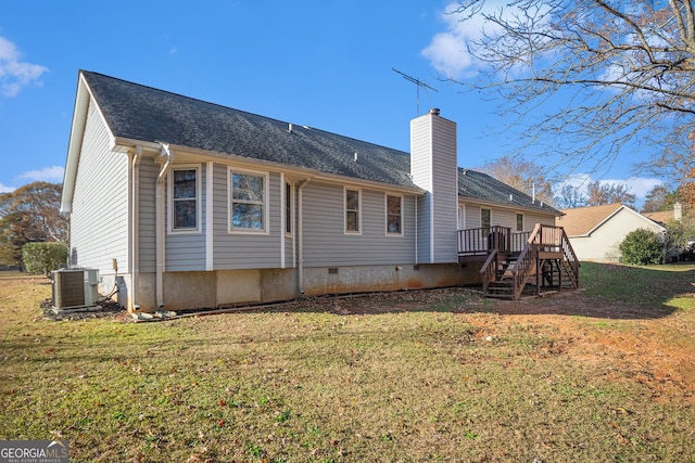 back of house featuring central air condition unit, a lawn, and a deck