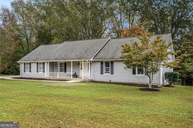 single story home featuring covered porch and a front yard